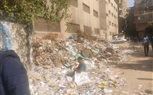 بالصور.. اضبط مخالفة.. تراكم أكوام القمامة بجوار أسوار المدارس فى العمرانية 