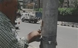 صيانة لأعمدة الإنارة وتأمين الكابلات بشارع باسيلى بالعمرانية